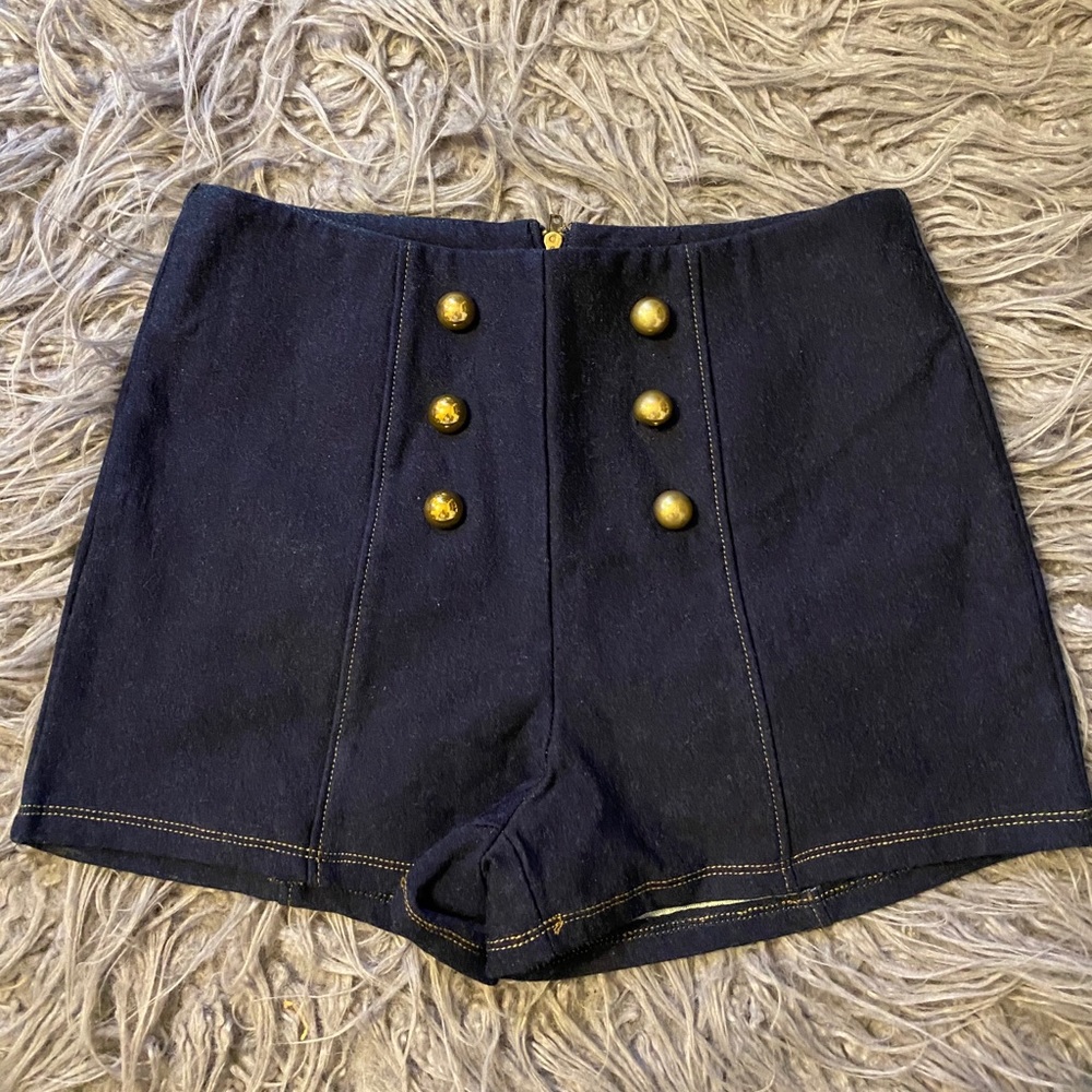 Dark blue denim shorts with gold buttons